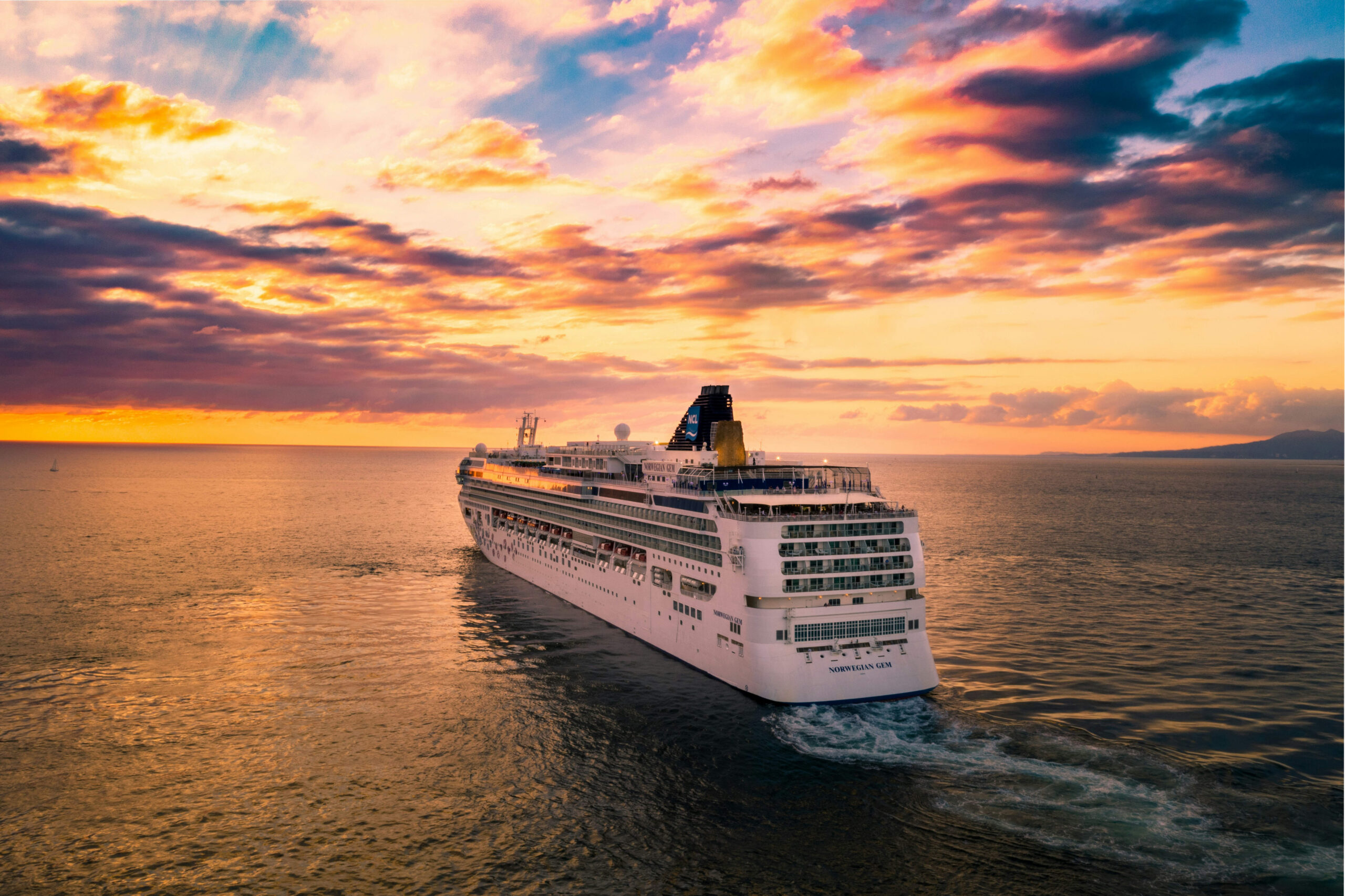 A cruise ship sailing into the sunset.